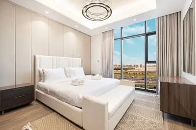 a bedroom with a white bed and a large window at 2 bedroom in heart of Business Bay - Dubai in Dubai