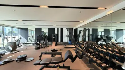 a gym with rows of chairs and tread machines at 2 bedroom in heart of Business Bay - Dubai in Dubai