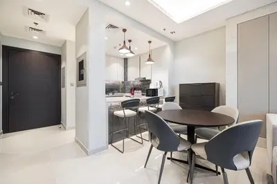 a kitchen and dining room with a table and chairs at 2 bedroom in heart of Business Bay - Dubai in Dubai