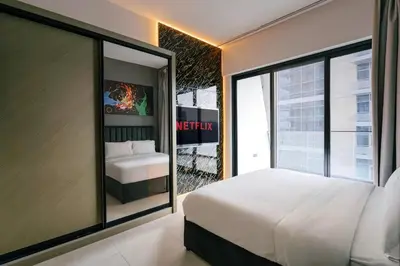 a bedroom with a large white bed and a window at Luxury 2BR Apt | Infinity Pool with Burj View in Dubai