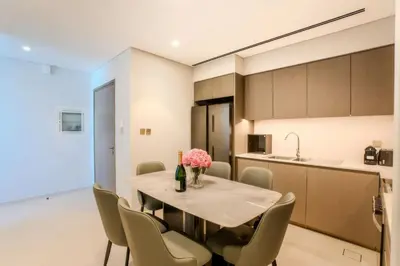 a kitchen and dining room with a table and chairs at Ultra-luxury apartment |Stunning Burj Khalifa view in Dubai