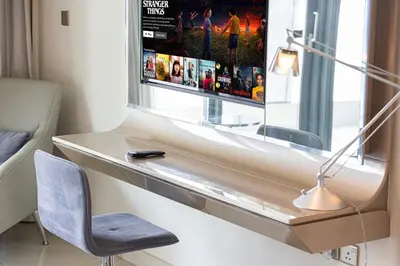 a room with a desk with a tv and a chair at 2 bedroom in heart of Business Bay - Dubai in Dubai
