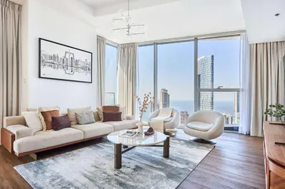 a living room with a couch and chairs and large windows at Frank Porter - Stella Maris in Dubai