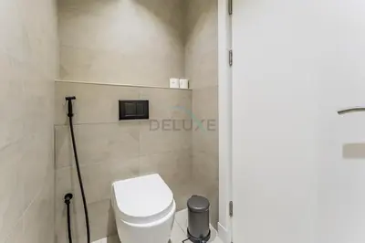 a bathroom with a white toilet in a room at Exclusive Waterfront Residence with Private Beach Access, Near Palm Jumeirah Mall and Restaurants - Jash Hamad Shoreline B18, Palm Jumeirah by Deluxe Holiday Homes in Dubai