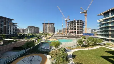an aerial view of a city with cranes at Contemporary 2BR in Central Park Viridian in Dubai