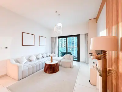 a living room with a white couch and a table at Burj Crown 3BR Skyline Retreat with Balcony in Dubai