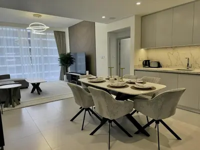 a kitchen and dining room with a table and chairs at BRAND NEW 2 BDR apartment with beach access in Dubai