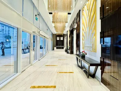 a hallway of a building with a bench and windows at Homes2Retreat - Stylish 1BR with Balcony in Business Bay in Dubai
