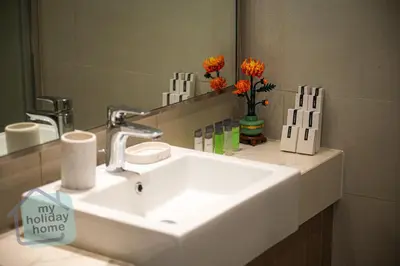 a bathroom with a sink and a mirror at Modern 1BR Azizi Riviera with Pool & Gym in Dubai