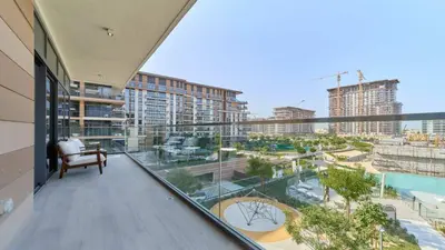 an apartment balcony with a view of a city at Modern 2BR in Viridian Central Park City Walk in Dubai