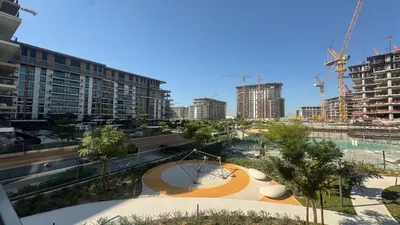 a view of a city with tall buildings at Modern 2BR in Viridian Central Park City Walk in Dubai
