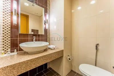 a bathroom with a sink and a toilet at Spacious 3BR and Assistant Room with Community View - Al Quortaj Villa, Al Furjan by Deluxe Holiday Homes in Dubai
