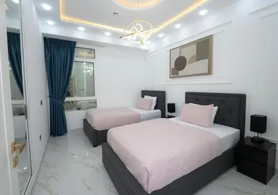 a bedroom with two beds and a window at Luxury 3 Bed flat in Marina crown in Dubai