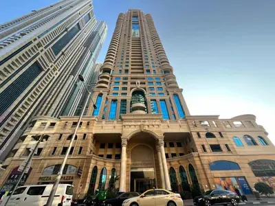 a tall building with cars parked in front of it at Luxury 3 Bed flat in Marina crown in Dubai