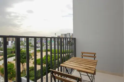 a balcony with a wooden table and two benches at Silk Valley - Luxury Villa | Steps to Park & Pool in Dubai