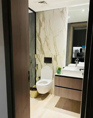 a bathroom with a toilet and a sink at Deluxe Studio for Rent in Oxford Gardens Dubai in Dubai