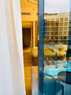 a room with a view of a living room at Deluxe Studio for Rent in Oxford Gardens Dubai in Dubai