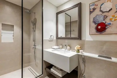 a bathroom with a white sink and a shower at Ultimate Beachfront family home with panoram views! in Dubai