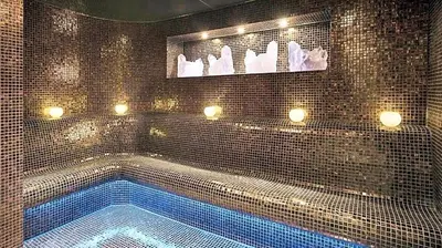 a bathroom with a swimming tub with lights on it at DAMAC COUR JARDIN - Near Metro - Free Parking in Dubai