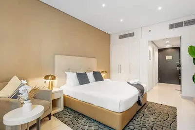 a bedroom with a bed and a couch at DAMAC COUR JARDIN - Near Metro - Free Parking in Dubai