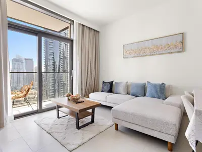 a living room with a couch and a table at Breathtaking 1 BDR w Partial Burjkhalifa View in Dubai