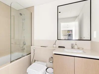 a bathroom with a toilet and a sink and a shower at Breathtaking 1 BDR w Partial Burjkhalifa View in Dubai