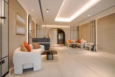 a lobby with couches and chairs and a table at Speedway Vacation Homes Rental LLC in Dubai