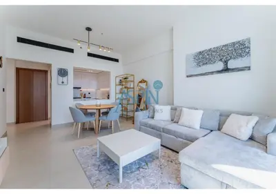 a living room with a couch and a table at Aspin Brand New Cozy 1BR at Binghatti Lavender JVC in Dubai