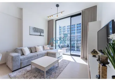 a living room with a couch and a large window at Aspin Brand New Cozy 1BR at Binghatti Lavender JVC in Dubai