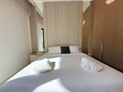 a large white bed with two pillows on it at Luxury 2BR in Creek Beach with Lagoon Access in Dubai