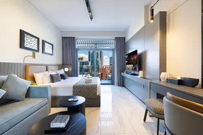 a hotel room with a bed and a couch at Luxury Canal View Studio for 4 Guests in Downtown, 5 Min to Dubai Mall in Dubai