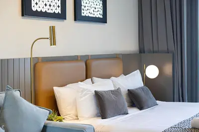 a bedroom with a bed with white sheets and pillows at Luxury Canal View Studio for 4 Guests in Downtown, 5 Min to Dubai Mall in Dubai