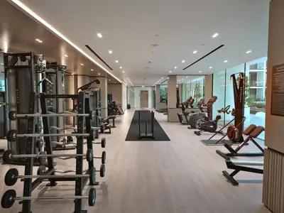 a gym with treadmills and elliptical machines at Bright 1-Bed with Pool and Gym in Dubai