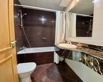 a bathroom with a toilet and a sink and a tub at OneBedroom Apartment with Partial Sea view in Dubai Marina - Z1106 in Dubai