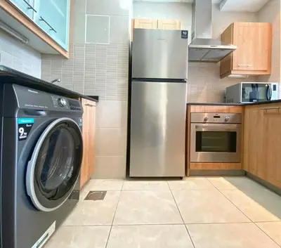 a kitchen with a stainless steel refrigerator and a washer at OneBedroom Apartment with Partial Sea view in Dubai Marina - Z1106 in Dubai