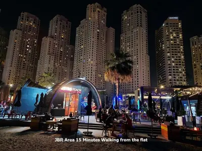 a large city at night with people sitting around tables at Studio - Dubai Marina - Partial Marina View Z1104 in Dubai