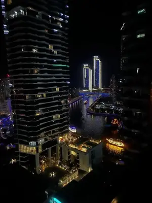 a view of a city at night with tall buildings at Studio - Dubai Marina - Partial Marina View Z1104 in Dubai