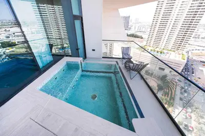 a swimming pool on the balcony of a building at StayShort - Modern 1 Bedroom with Private Jacuzzi in JVC that Sleeps 2 in Dubai