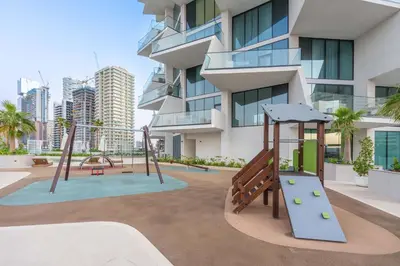 a playground in front of a building with a slide at StayShort - Modern 1 Bedroom with Private Jacuzzi in JVC that Sleeps 2 in Dubai