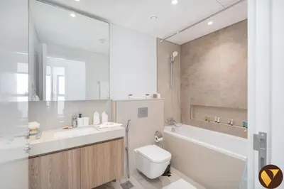 a bathroom with a sink and a toilet and a tub at Vogue Downtown Views II with Direct Access to Dubai Mall Via a Climate Controlled Bridge, One Bedroom Apartment with Balcony and City View in Dubai
