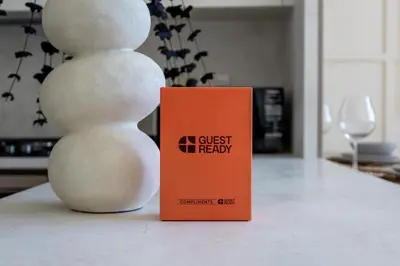 an orange book sitting next to a stack of snowmen at GuestReady - Luxe Stay with Private Pool in Dubai