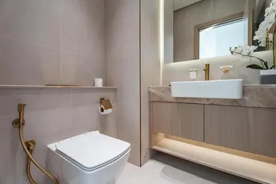 a bathroom with a white toilet and a sink at GuestReady - Luxe Stay with Private Pool in Dubai