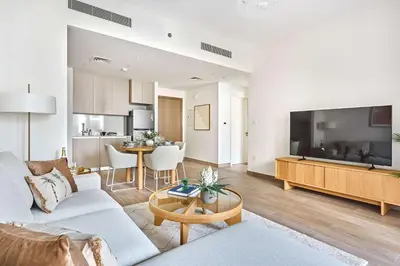 a living room with a couch and a table at Frank Porter - Grove at Creek Beach Building in Dubai