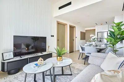 a living room with a couch and a table at Frank Porter - Binghatti Corner in Dubai