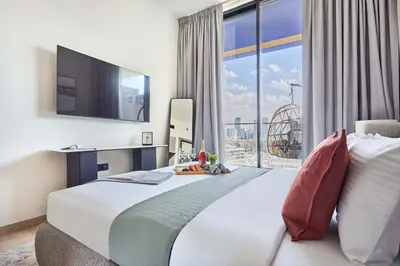 a hotel room with a large bed and a large window at Frank Porter - Binghatti Corner in Dubai