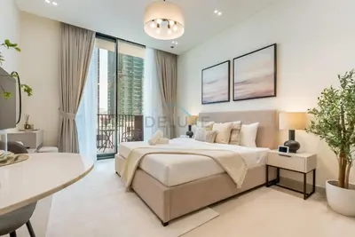 a bedroom with a large bed and a desk at Prime Location, Walking Distance to Circle Mall, Minutes Drive from Dubai Marina and Palm Jumeirah - Binghatti Aurora, JVC by Deluxe Holiday Homes in Dubai