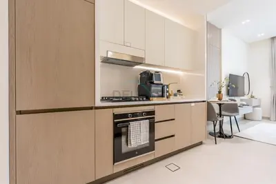 a kitchen with a stove and a microwave at Prime Location, Walking Distance to Circle Mall, Minutes Drive from Dubai Marina and Palm Jumeirah - Binghatti Aurora, JVC by Deluxe Holiday Homes in Dubai