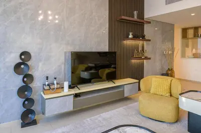 a living room with a table and a chair at Stunning Apartment - Downtown View 2 - Tower 1 - Fountain and Burj Khalifa view 61st floor in Dubai