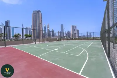 a tennis court in the middle of a city at Vogue Downtown Views II with Direct Access to Dubai Mall Via a Climate Controlled Bridge, One Bedroom Apartment with Balcony and City View in Dubai