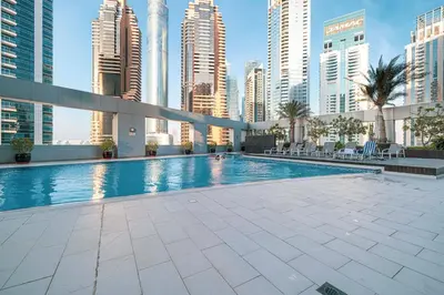 a swimming pool in a city with tall buildings at Marina Escape Spacious Skyview 2BR in Dubai